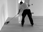 Bauwerk employee cleans parquet by Bauwerk